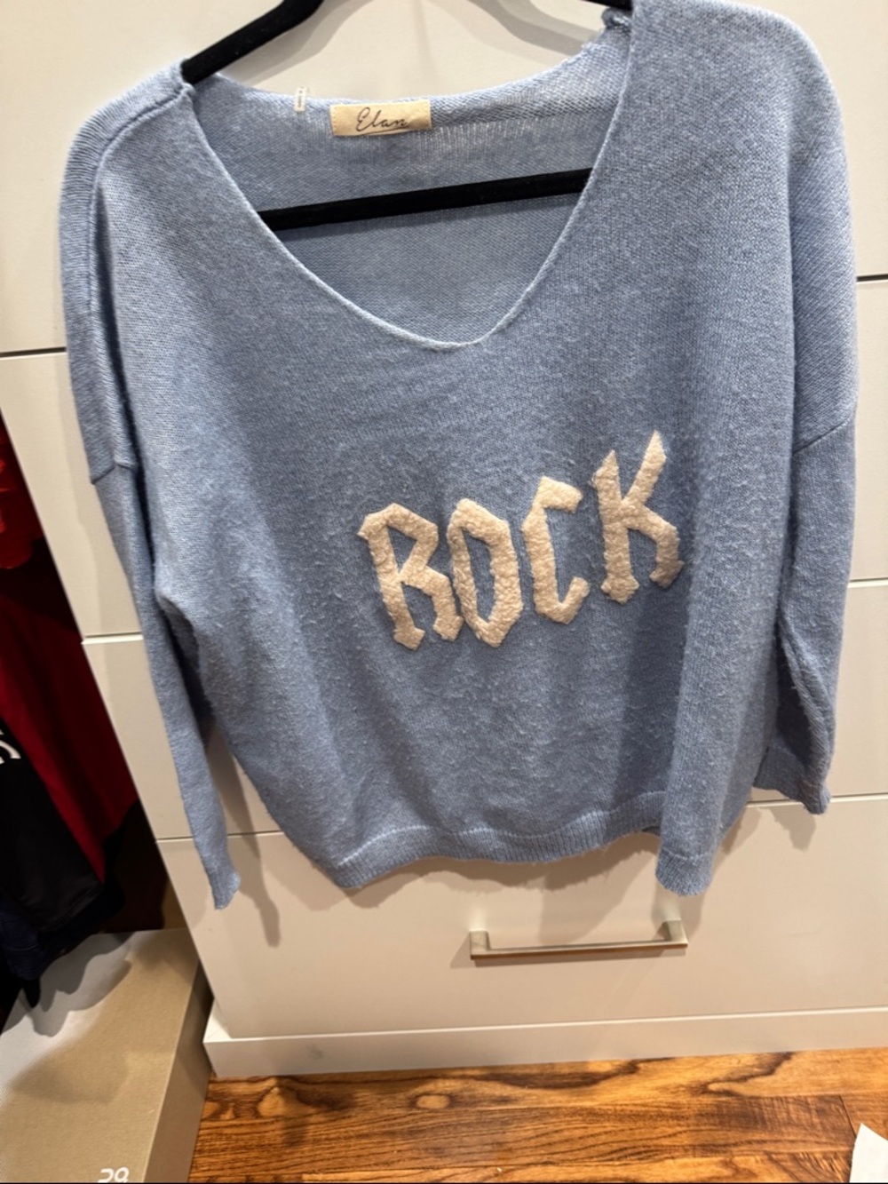 Elan Light Blue V-Neck Sweater with Cream 'ROCK' Appliqué